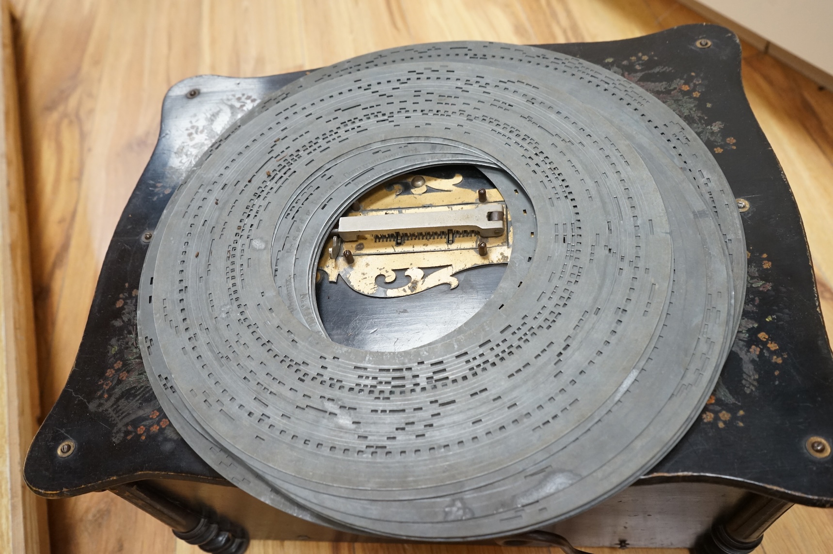 An early 20th century Organette Phoenix in an ebonised case, together with a selection of nineteen related and unrelated discs in three different sizes; five 37cm diameter discs, three 33.3cm diameter discs and eleven 31